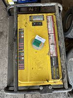Top view of the yellow panel showing control interface and warning labels.