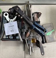 View of lot showing Mastercraft hand riveter on top, flare tool, and various small metal tools in background.