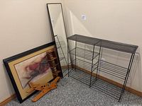 Wooden airplane wall mount coat rack, metal wire 5-tier stand, framed mirror and wine rack placed on floor