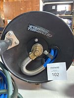 Top view of hose reel showing Campbell Hausfeld branding and metal swivel connection for hose.