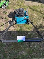 Front view of Yardworks 21-inch gas powered lawn mower on grass showing overall condition and handlebar.