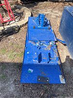 Full top view of blue diamond-plate lift platform on ground