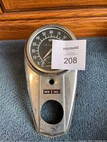 Front view of motorcycle speedometer and dashboard unit showing MPH, odometer, RPM, and indicator lights.