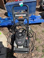 Front view of the Diamond pressure washer showing the full machine, with visible branding and coiled hoses.
