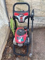 Front view showing Simpson label, Honda engine and coiled green hose on frame