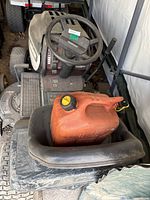 Front view showing steering wheel, dashboard and red fuel container on seat