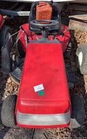 Front view of red Mastercraft riding mower with gas can on seat