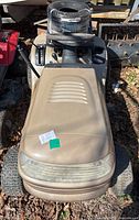 Top-front view of beige Craftsman mower showing hood, steering control and front wheels