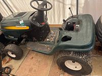 Full side and steering area of Craftsman LT1000 riding lawn mower, showing controls and seat area