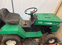 Left-side view showing overall chassis, seat, steering wheel, engine cover marked “12 HP Rally”