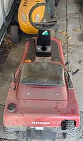 Front view of Craftsman riding lawnmower showing steering wheel, seat, and body condition.