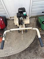 Overhead view showing handlebar grips, frame, engine and tines.