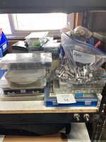 Overview photo showing stacked plastic boxes, a large Ziploc bag filled with metal fasteners including bolts and nuts, and smaller boxes containing assorted fasteners.