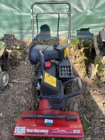 Front view of red and black Yard Machines 22-inch snow blower showing brand and model labels, handlebar, and discharge chute.