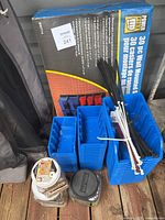 Photo of the blue and red storage bins, zip ties, and jars of screws and nails showing all items included in the lot.