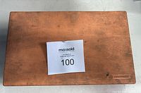 Closed wooden case housing the Mitutoyo depth micrometer set, showing the top lid with a slight patina and a maker's mark embossed on corner.