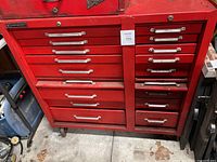 Front view showing full width left drawers and narrow right drawers, caster wheels