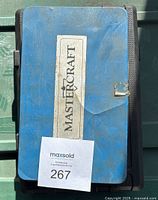Blue metal closed case with Mastercraft label and MaxSold lot number attached.