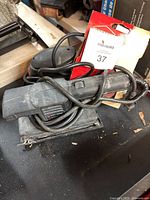 Black & Decker 7448 finishing sander with attached power cord, worn sanding base visible