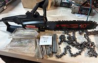 Mastercraft electric chainsaw with sharpening files and extra chain on workbench