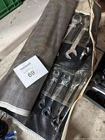 Wrenches arranged in the black roll-up pouch with clear plastic pockets showing individual wrench sizes.