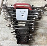 Top view of wrench set with red handle rack and 15 combination wrenches arranged from large to small.