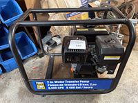 Front view of Power Fist 2 inch water transfer pump showing metal frame, engine, and pump unit with branding and flow rate labels.
