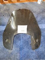 Top view of the black motorcycle windscreen showing front shape and mounting points