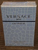 Front view of the Versace Man Eau Fraîche box showing brand name, product line and size.