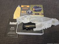 Full lot overview showing the red dot sight inside foam packaging with cloth, manual, and box visible.