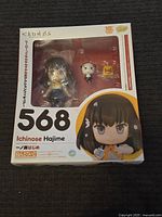 Front view of the boxed Ichinose Hajime figure, showing figure and accessories visible through plastic window.
