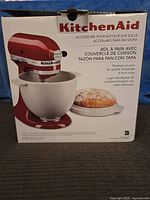 Box showing KitchenAid branding and bread baking bowl with a lid accessory image and product description