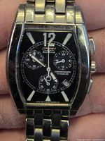 Front view of the men's Citizen Eco-Drive chronograph watch showing rectangular black dial with chronograph subdials, luminous markers, and titanium case.
