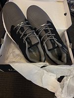 Pair of grey and black U.S. Polo Assn. casual shoes in original box with tissue paper.