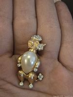 Close-up front of the brooch showing pearl and rhinestone details.