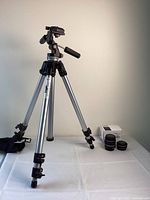 Full view of Bogen tripod on table with Canon lenses and original box on the side