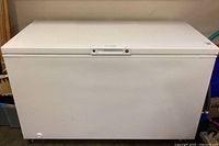 Front view of white Frigidaire chest freezer, lid closed