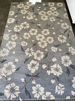 Full view of the gray floral area rug showing the overall design and pattern.