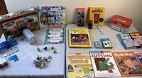Overview of educational materials, books, flashcards, and games on white tabletop.