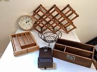 Photo showing all items together on a table: clock, wine rack, bamboo organizer, metal basket, rustic wooden organizer, and wooden wall-mounted item