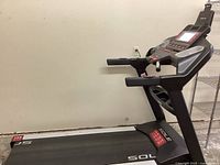 Side-angled full view of assembled treadmill showing deck, frame and console