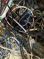Tangled assorted wires and cables in multiple colors and types, showing variety of cables and connectors