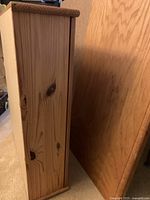 Side view of light wood storage cabinet showing wood grain and thickness