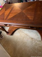 Top view of the wooden desk showcasing the patterned wood inlay on the top surface.
