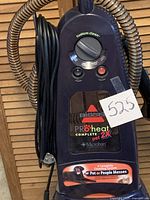 Front view of Bissell ProHeat Complete 2X Pet carpet cleaner showing control dial and power button.