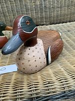 Close-up of handcrafted wooden Greenwing Teal duck decoy showing painted details and texture.