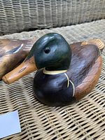 Front angled view of the wooden duck decoy showing detailed paintwork and carving.