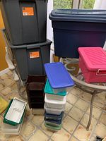 Wide view of all plastic storage containers grouped together showing variety of sizes and colors.
