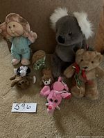 Overall lot of stuffed animals including Cabbage Patch doll, koala, teddy bear, and other assorted plush toys