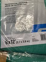 Label of a green polyethylene tarp showing 9x12 feet dimensions, waterproof and rust-resistant features